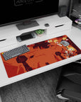 36x16 inches anime desk pad showing a blond scarfed hero tumbling midair, sword drawn over ruins.