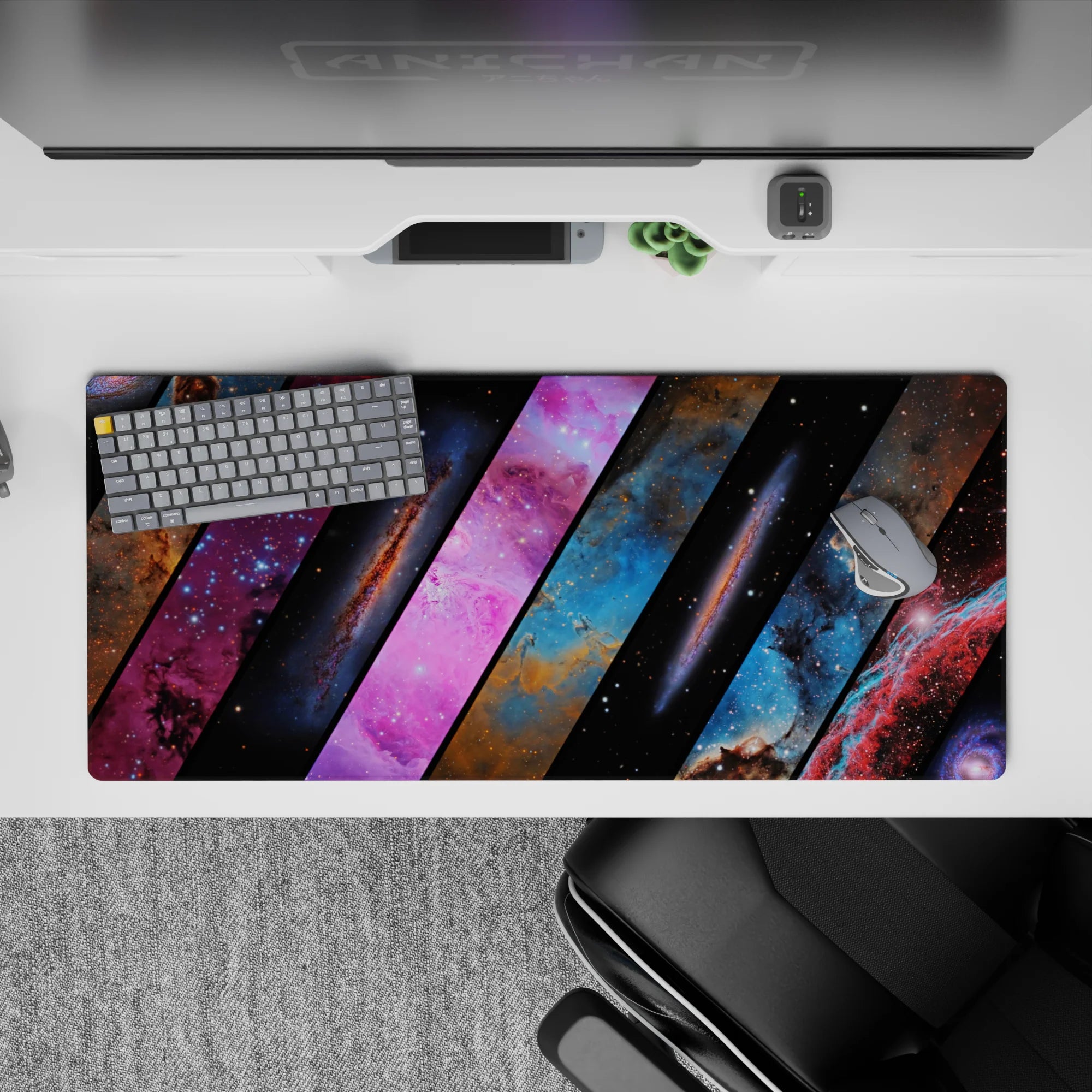 Midnight black desk pad, 36x16 inches, in dreamy blues and hot pink nebula clouds, calm cosmic vibe.