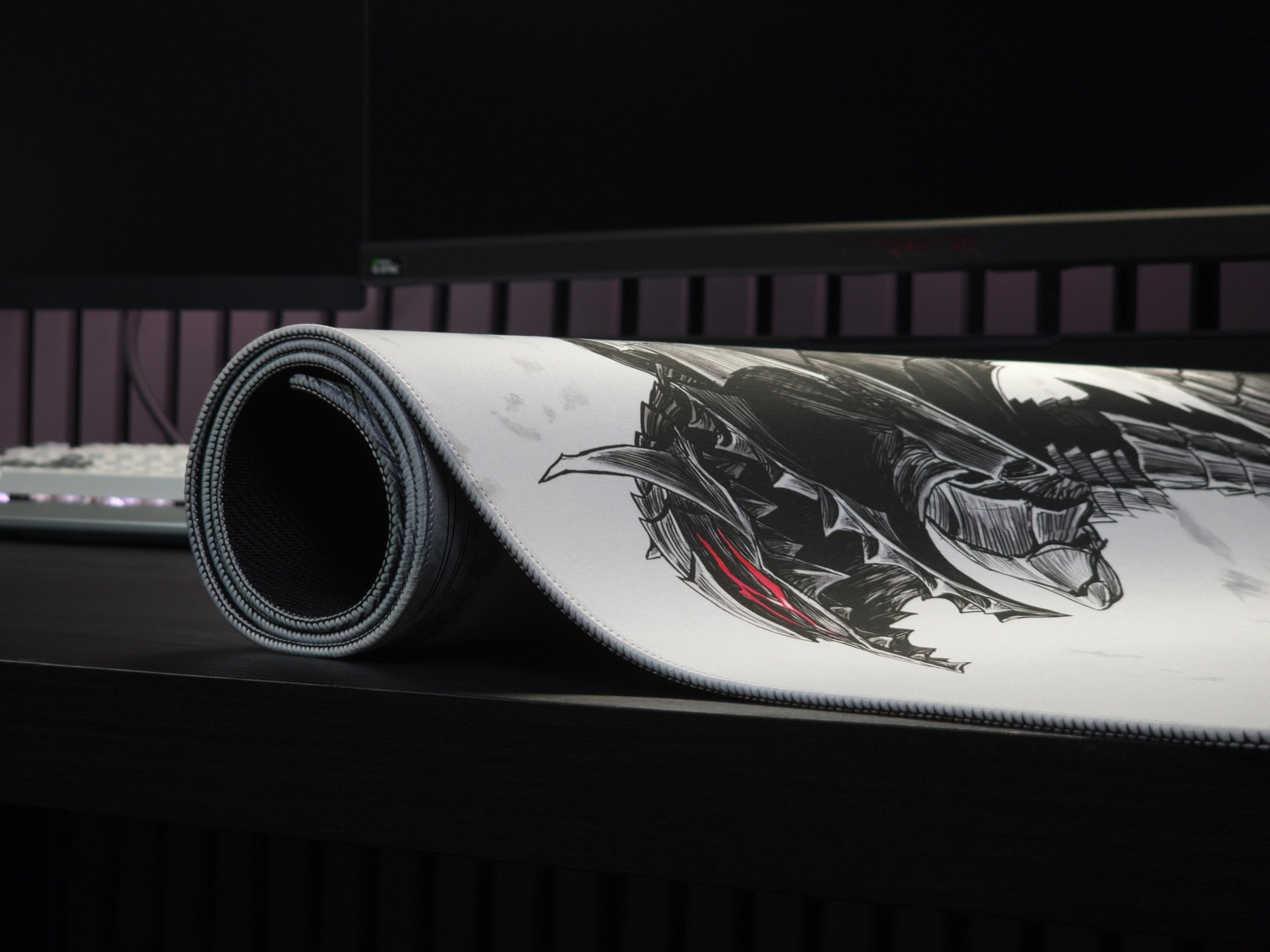 Rolled premium anime desk mat showcasing durable stitched edges, smooth cloth surface, and high-quality print on a gaming desk.