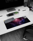 Starry space scene mouse pad, 28x12 inches, featuring swirling nebula clouds and tiny specks of light.