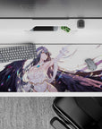 Albedo from Overlord on a 36x16 inch anime desk pad, showcasing her fierce and serene look with wings and floating feathers.