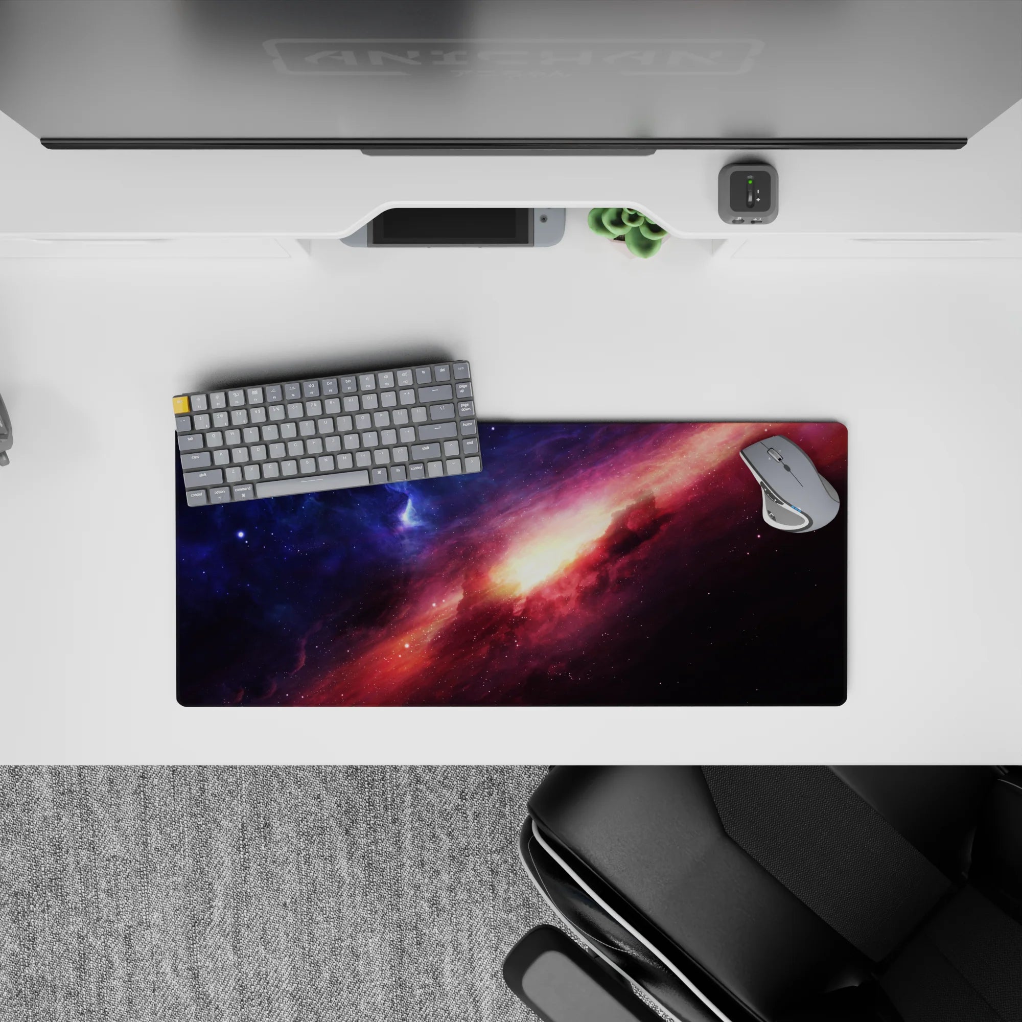 Cosmic desk mouse pad 28x12 inches in deep blue and rosy magenta tones with a warm sunrise-like core.