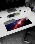 Space scene mouse pad 28x12 inches featuring a sweeping nebula streak across a star-speckled night sky.