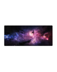 Cosmic nebula desk mouse pad 28x12 inches with star-speckled galaxy swirl design on dark backdrop.