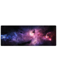 Dreamy nebula galaxy desk mouse pad 32x12 inches with star specks and swirling cosmic clouds.