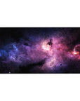 Cosmic nebula desk pad 40x20 inches with star-speckled swirls across a dark space backdrop.