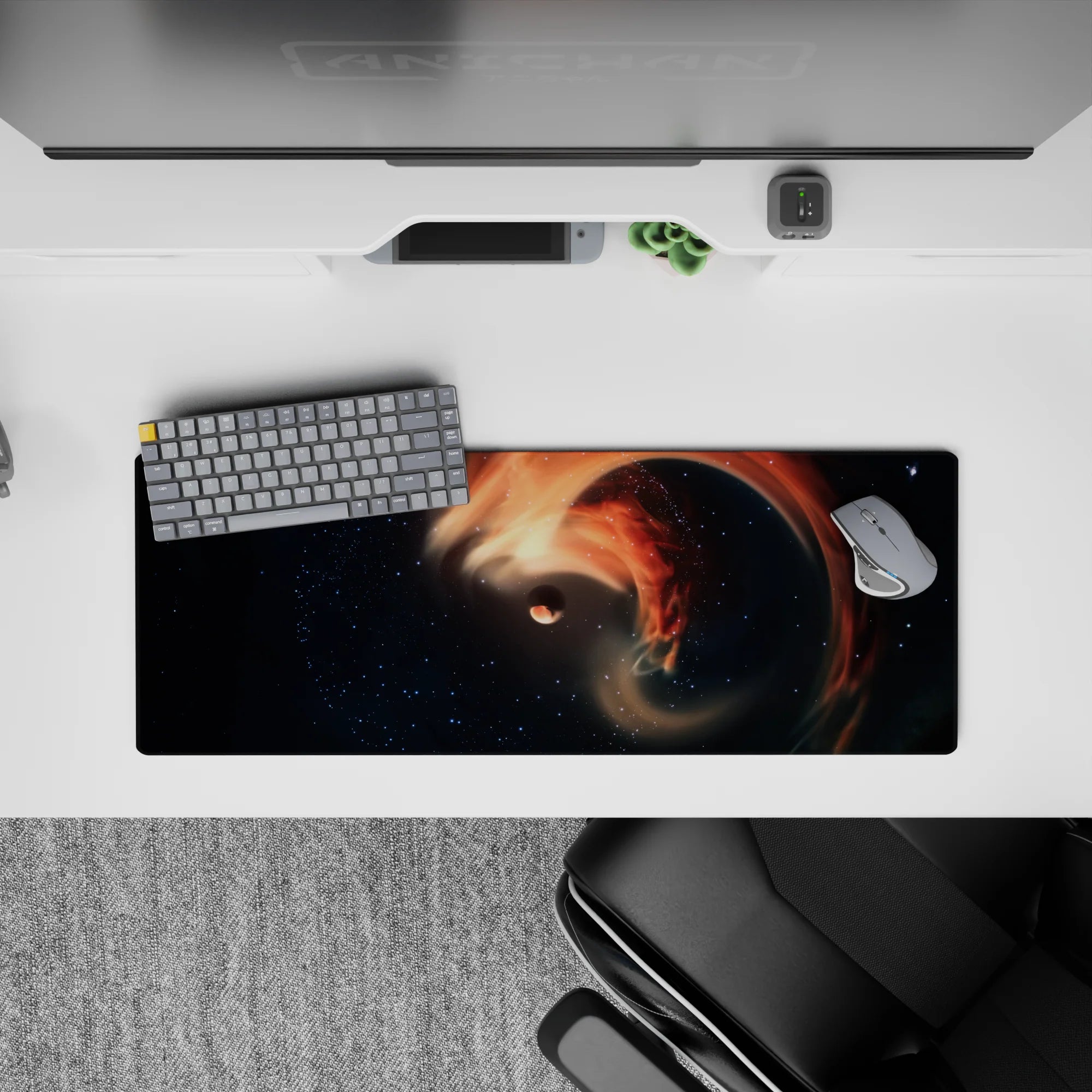 Dreamy deep-space desk pad 32x12 inches in smoky black and star-dusted navy with warm orange accents.