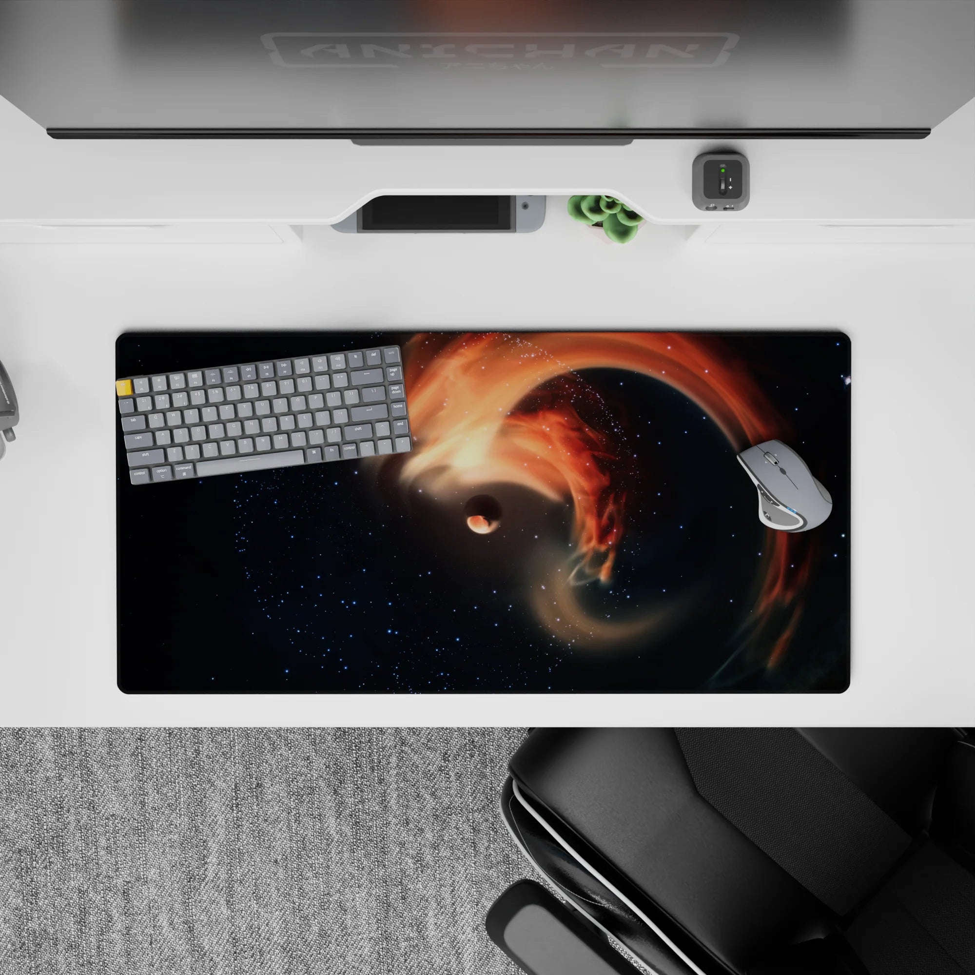 Dreamy deep-space mouse pad 32x16 inches in star-dusted navy and black with warm orange accents.