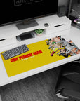 Saitama gliding forward with calm face and red gloves on a 36x16 inches anime desk pad, Genos behind.