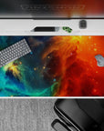Dreamy bold desk pad 40x20 inches in teal and ocean blue fading into fiery orange and red.