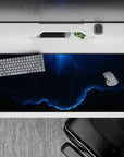 Moody deep navy and electric neon-blue glow desk pad 36x16 inches with calm cosmic gradient vibe.