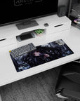 Dark-haired anime girl with ruby eyes holding a tiny flower to her lips on mouse pad 28x12 inches.