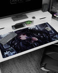 Ruby-eyed dark-haired anime girl with roses, holding a tiny flower to her lips on 40x20 inches desk pad.