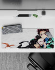 Tanjiro and Nezuko from Demon Slayer on a 32x12 inch anime mouse pad, showcasing their fierce bond and protective stance.