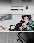 Tanjiro and Nezuko Demon Slayer desk pad 36x16 inches, showcasing fierce loyalty and sibling power against a snowy canvas.