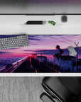 Cotton-candy neon pink and violet sunset desk pad 36x16 inches, calm late-night city glow vibe.