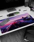 Schoolgirl on rooftop edge, windblown hair and dangling sneakers anime desk pad 40x20 inches.