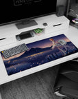 Redheaded anime girl in feathered white dress by a quiet lake, city glow behind, desk pad 36x16 inches.