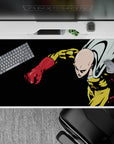 Black backdrop, bold yellow suit and red gloves anime desk pad 40x20 inches with stormy cape vibe.