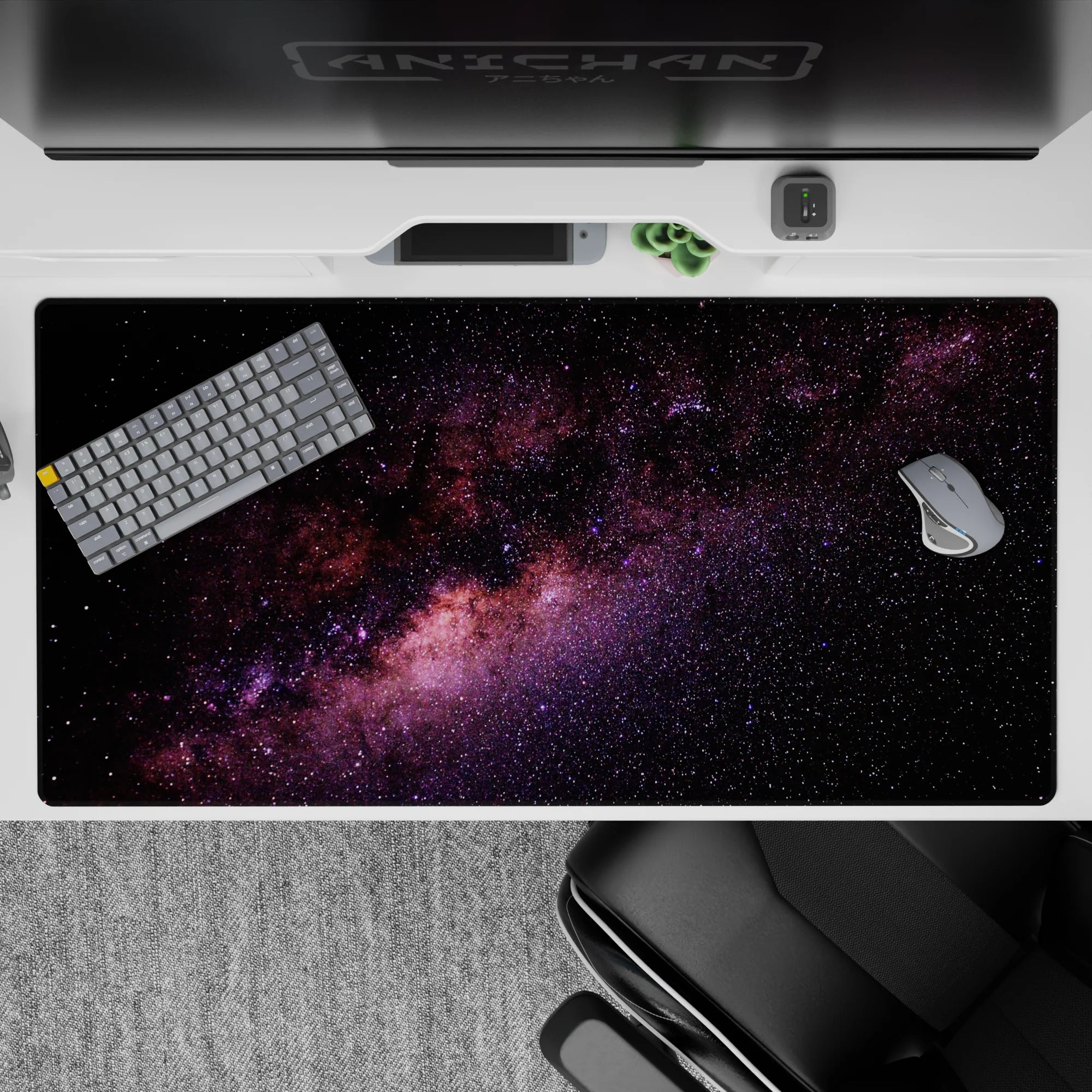 Calming night-sky desk pad 40x20 inches in inky black with purple and blush nebula hues.
