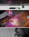 Dreamy space mood desk pad 40x20 inches in smoky purples, warm oranges, and soft starlight.