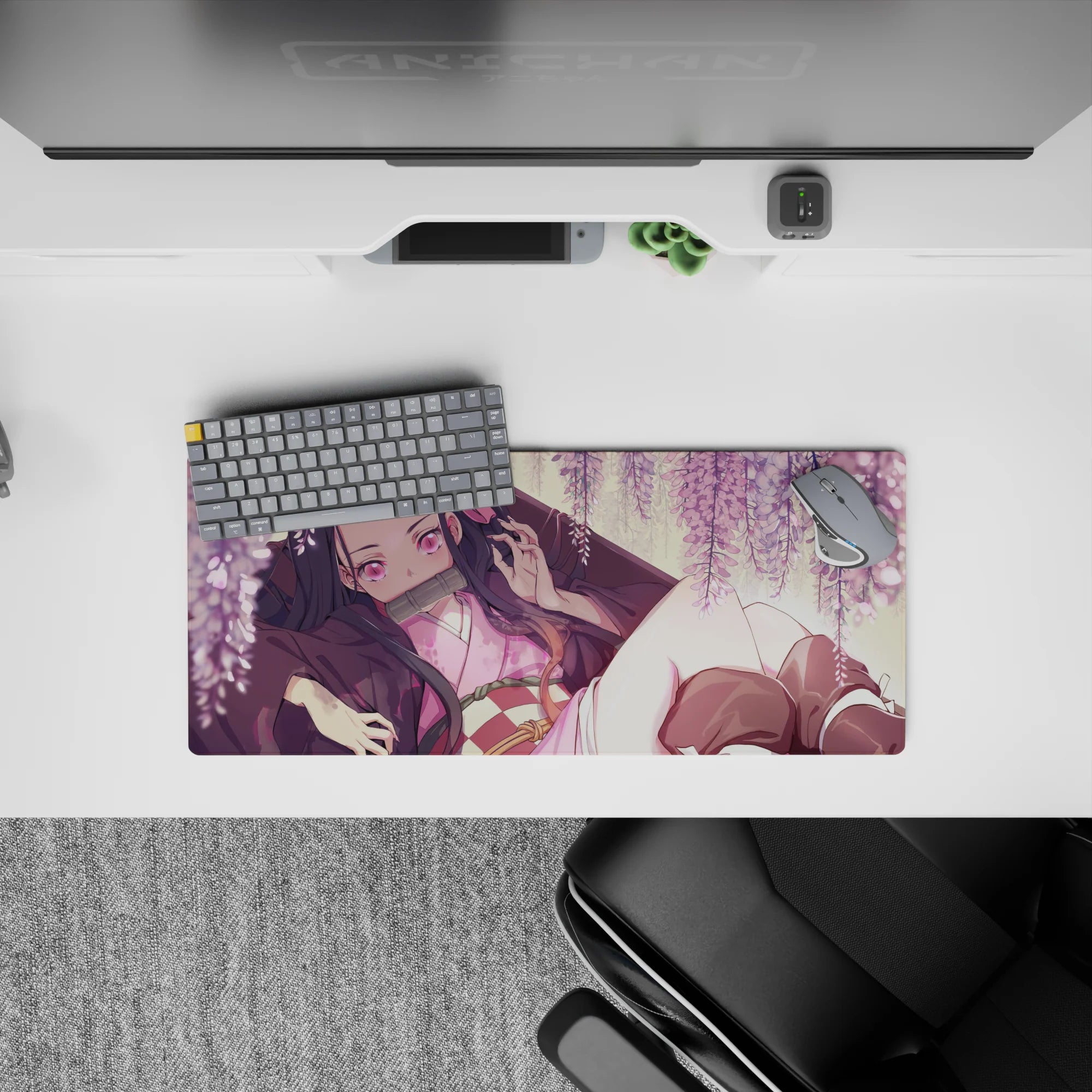 Nezuko from Demon Slayer lounges under wisteria on a 28x12 inch anime mouse pad, surrounded by blush-pink blooms.