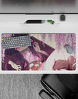 Nezuko from Demon Slayer lounges under wisteria on a 32x16 inch anime mouse pad, surrounded by blush-pink blooms.