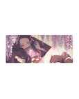 Nezuko from Demon Slayer on a 28x12 inch anime mouse pad, surrounded by blush-pink wisteria, creating a cozy, dreamy scene.