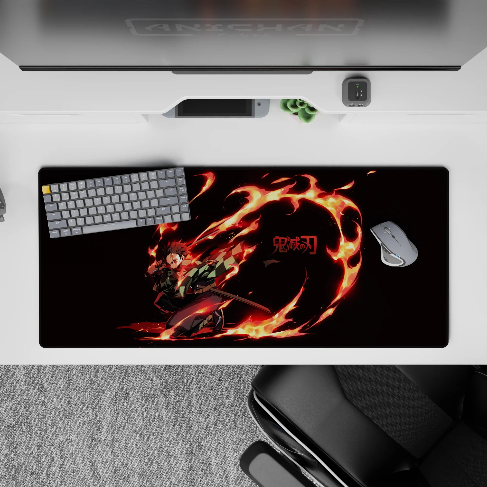Tanjiro from Demon Slayer on a 36x16 inch desk pad, showcasing fiery arcs and vivid colors that stand out on a dark background.
