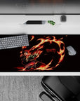 Tanjiro from Demon Slayer on a 36x16 inch desk pad, showcasing fiery arcs and vivid colors that stand out on a dark background.