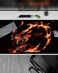 Tanjiro from Demon Slayer on a 40x20 inch anime desk pad, featuring vivid flames and intense colors for a striking effect.