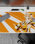 Sunny hero anime desk pad 40x20 inches in warm orange, white, gold, and peach tones.