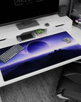 Giant moon over dark mountain silhouettes desk pad 40x20 inches under a violet alien sky.