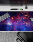 Moody navy desk pad 40x20 inches in electric blues and magenta clouds for cozy cosmic vibes.