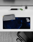 Moody cosmic mouse pad 28x12 inches in inky black and deep ocean blues with electric blue highlights.