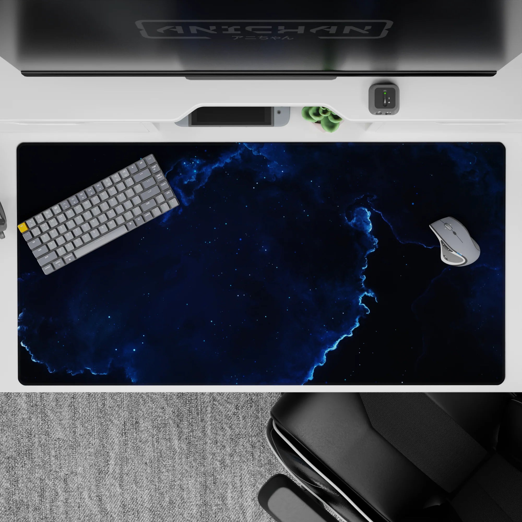 Moody cosmic desk pad 40x20 inches in deep ocean blues and black with electric blue cloud edges.