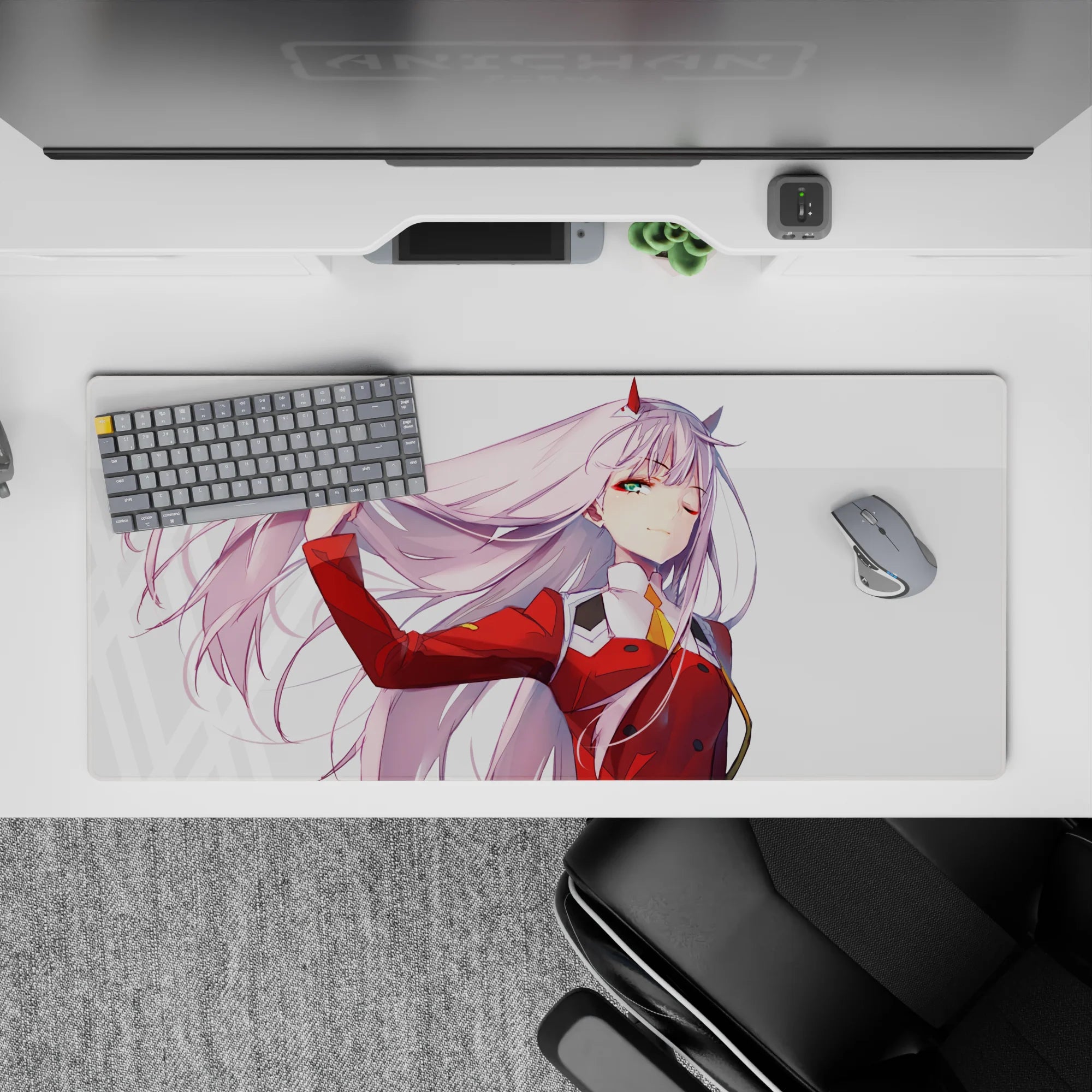 36x16 inches desk pad with Zero Two from Darling in the Franxx, capturing a powerful moment of confidence with her pink hair flowing in the wind.