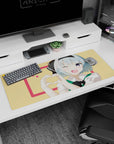 Blue-haired anime girl with big violet eye winking and making a hand-heart on 36x16 inches desk pad.