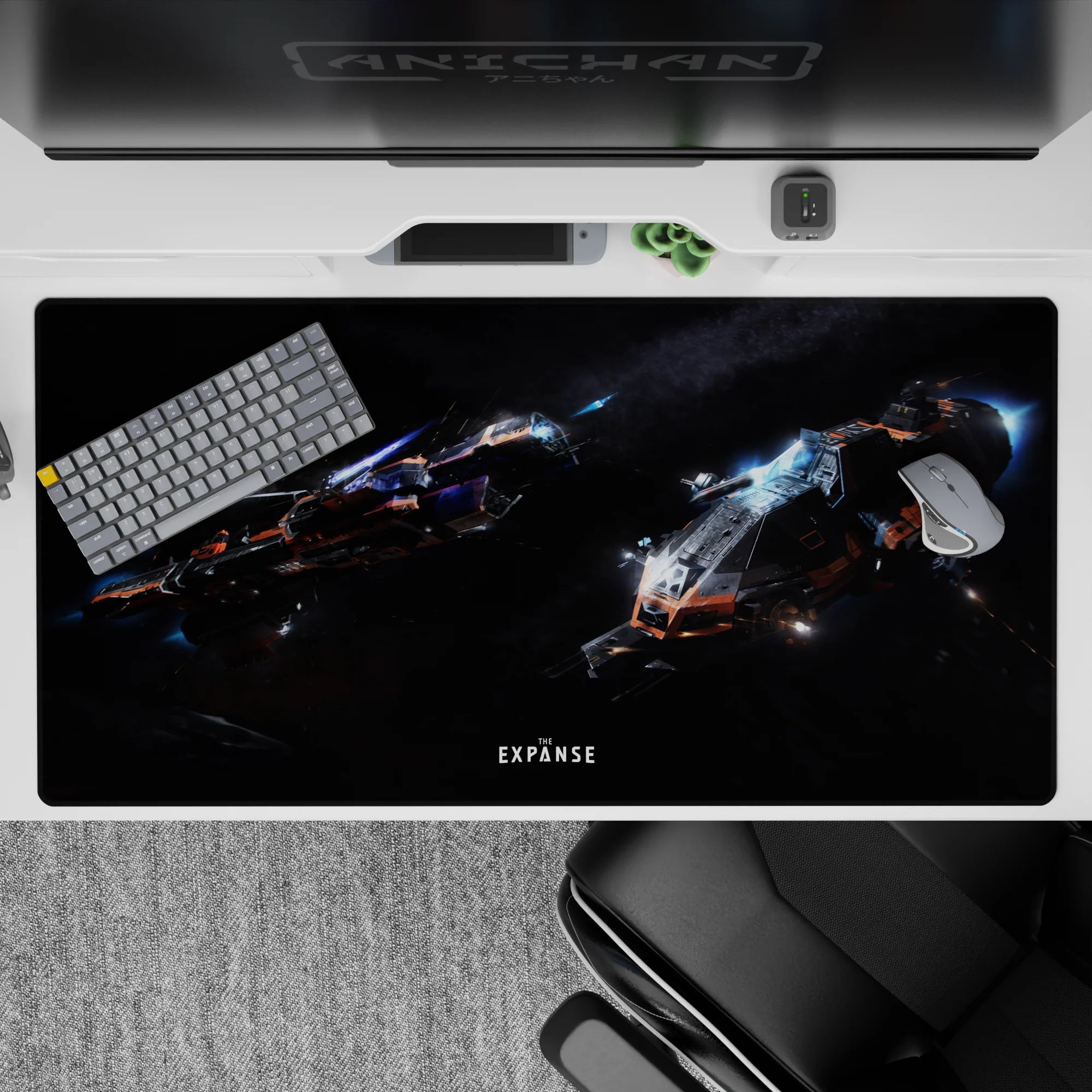 Cinematic dark space desk pad in smoky black with cool blue glow and orange accents, 40x20 inches.