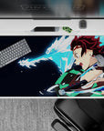 Tanjiro from Demon Slayer on 40x20 inch anime desk pad, water dragon attack, navy backdrop with checkered haori.