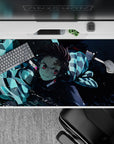 Tanjiro from Demon Slayer in action, water-breathing style on 40x20 inch anime mouse pad, vibrant blues and dynamic design.