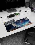 Icy peaks beneath a crimson planet in a starry sky desk mouse pad, 28x12 inches.