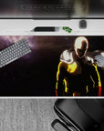 Stormy charcoal anime desk pad 40x20 inches with bold yellow suit and red gloves, intense mood.