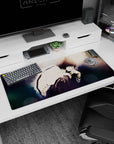 36x16 inches anime desk pad showing brooding boy in white shirt, knees hugged close, hand near lips.