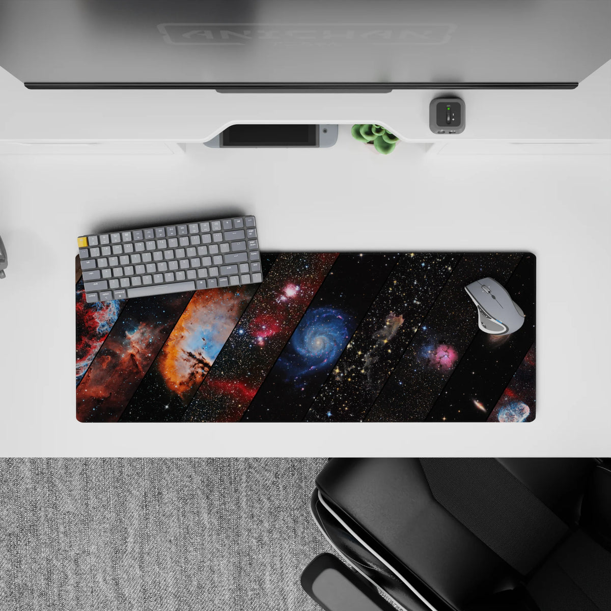 Moody space desk mat 32x12 inches in teal, ember orange, blush pink, deep blue on inky black.
