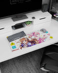 28x12 inches mouse pad showing brown-curled horn girl grinning beside pink-haired headphone girl staring over shoulder.