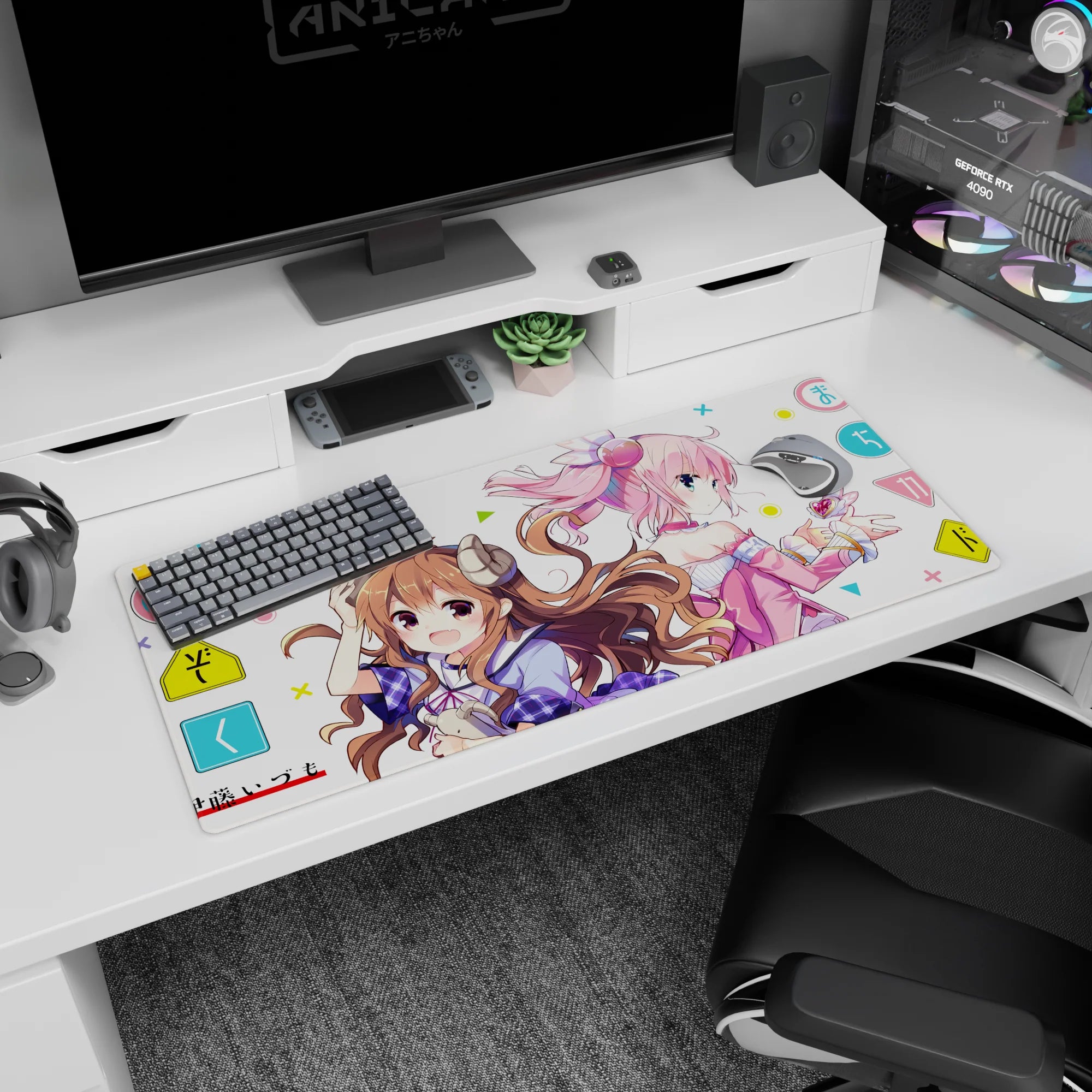 36x16 inches anime desk pad showing brunette with tiny horns smiling beside pink-haired girl in headphones.