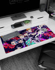 Mob reaches forward with blazing eyes as Reigen reacts on anime desk pad, 36x16 inches.