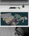 Anime mouse pad 32x16 inches featuring Inosuke from Demon Slayer mid-punch with a deep teal backdrop highlighting details.