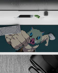 Anime desk pad 36x16 inches featuring Inosuke from Demon Slayer, mid-punch with boar mask, on a deep teal backdrop.
